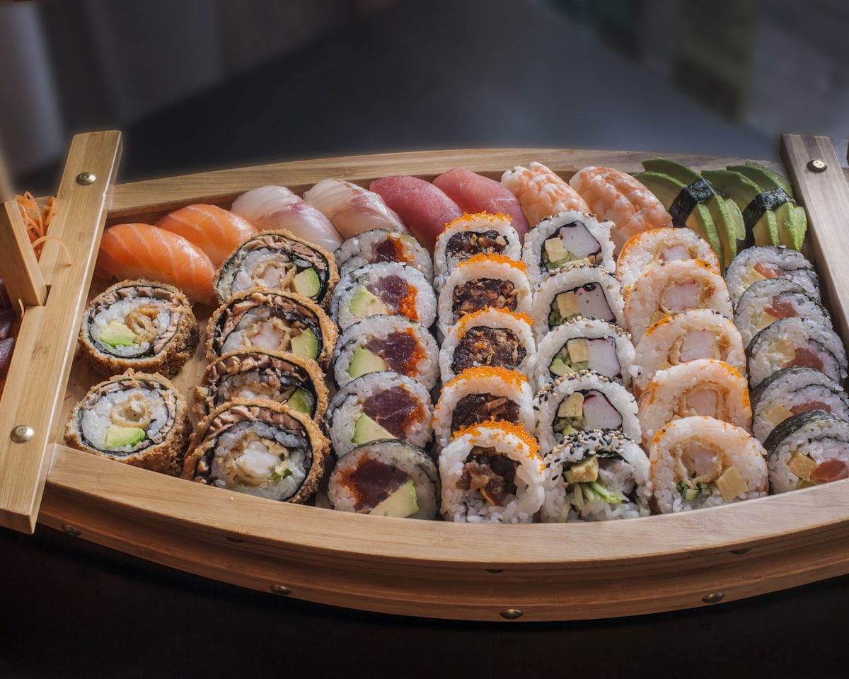 A laden sushi boat of assorted rolls and nigiri